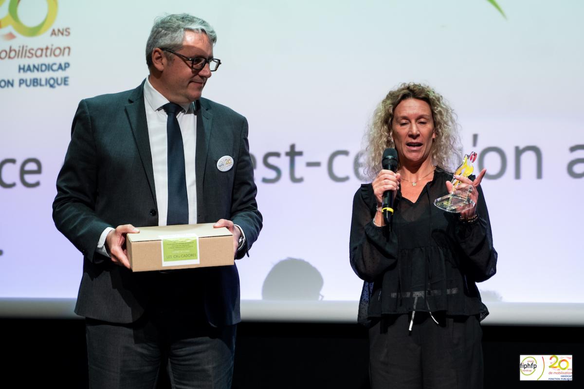 Claire Rousseau, référente handicap de la Ville d'Annecy, reçoit le trophée Coup de coeur du Public des mains de Guillaume Bonneville, DTH du FIPHFP en Auvergne Rhône Alpes